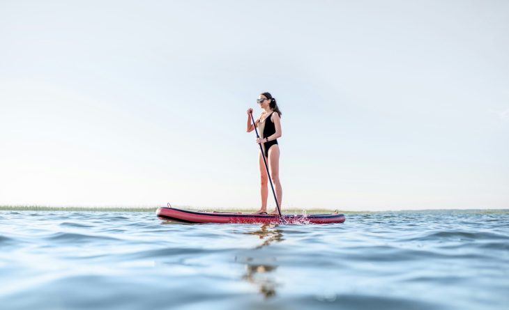 A woman paddle boarding