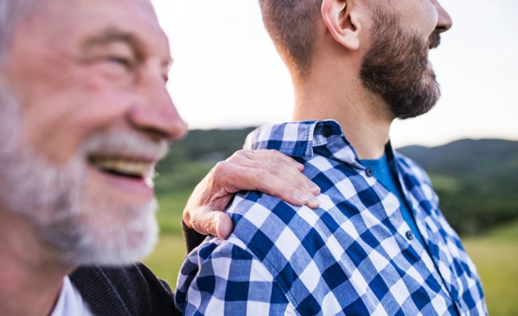 A father and adult son looking into the distance