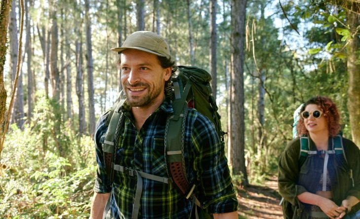 Two people hiking through a forest